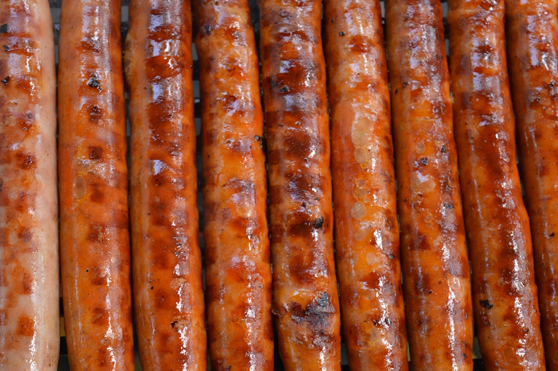 a close up of a bunch of sausages on a grill