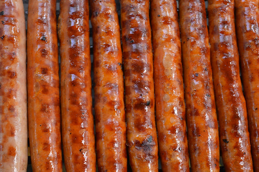 a close up of a bunch of sausages on a grill